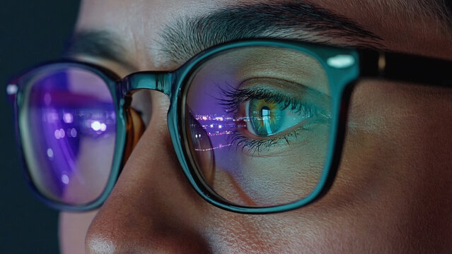 Eye with Glasses and Reflection: Close-up of an eye wearing glasses with an immersive reflection, a glimpse into the digital world. Capturing the intensity of focus.