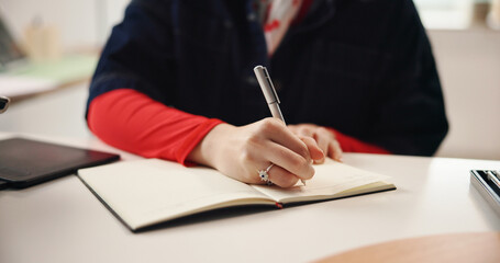 Remote work, hands and writing with notebook for graphic design, planning or idea inspiration. Freelancer, tablet and creative woman with schedule for project draft, reminder and diary in home