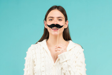 Girl, moustache and happy with prop. Comic woman portrait. Funny face with moustache on stick. Funny woman holding paper moustache party stick. Girl holding funny mustache.