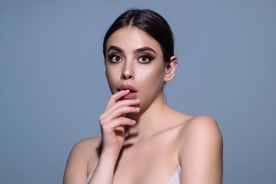 Emotional student girl shocked with news covering mouth with hands. Young emotional woman. The human emotions, facial expression concept. Amazed girl with shocked facial expression.