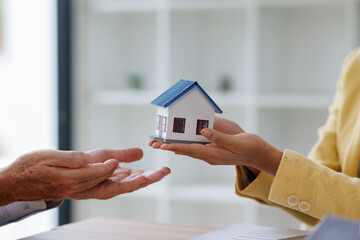 Estate business agent giving house Real estate transaction with agent giving house keys to client...