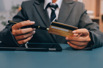 Online payment,businessman hands holding credit card and using  laptop for online shopping. Cyber Monday Concept