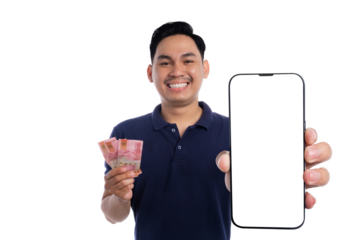 Smiling man holding Indonesian rupiah banknotes and showing blank smartphone screen isolated on transparent background