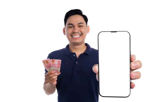 Smiling man holding Indonesian rupiah banknotes and showing blank smartphone screen isolated on transparent background - Powered by Adobe