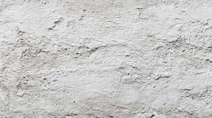 Obraz premium A rough, textured white wall displays variations in surface and color, reflecting light in a residential setting during daylight hours.