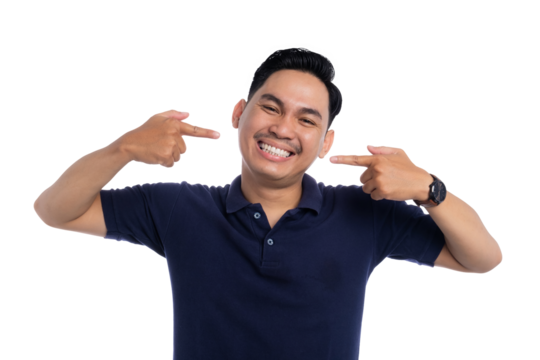 Happy smiling man proudly pointing at his teeth with both hands showing confidence and dental care isolated on transparent background