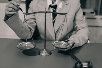 Judge gavel with Justice lawyers having team meeting at law firm background. Concepts of Law and...