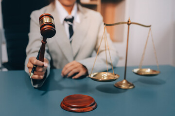 Judge gavel with Justice lawyers having team meeting at law firm background. Concepts of Law and...