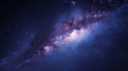 Fototapeta premium A breathtaking view of the galaxy showcases vibrant hues of blue and purple. Stars shine brightly across the dark night sky, revealing the beauty of the universe during a serene evening.