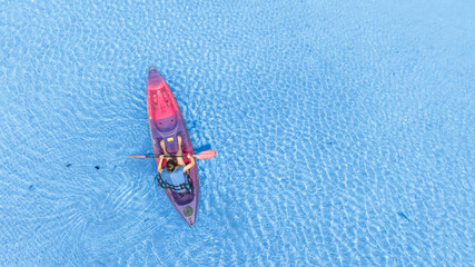 Aerial view of a kayak in the blue sea .man kayaking he does water sports activities.	