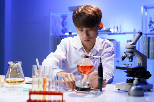 Scientist heating chemical solution in laboratory experiment