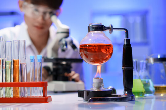 Chemical experiment with heated flask in laboratory - Powered by Adobe