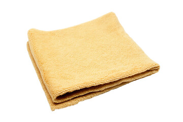 a yellow towel folded on top of a white surface