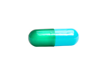 a green and blue pill sitting on top of a white surface