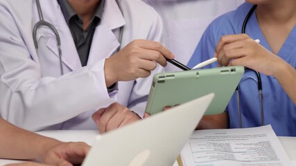 Professional group of medical working and planning medical treatment or healthcare system at hospital table together. Teamwork lead to successful illness and sickness treatment. Slow motion. Rigid. - Powered by Adobe