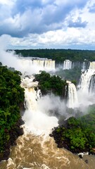 Fototapeta premium Iguazu Falls, lush jungle backdrop