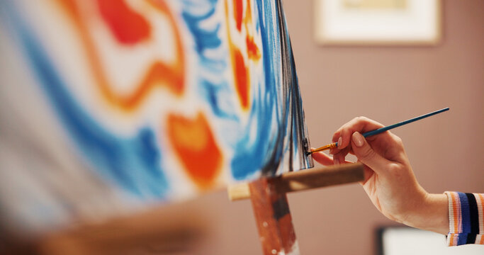 Hand, paint brush and stroke on canvas at workshop, color or creative process with design for artwork. Person, artist and lines with talent, inspiration and tools with abstract project at home studio - Powered by Adobe