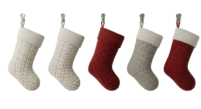 Four Christmas stockings, knitted in cream, gray, and red, hanging on hooks, ready for holiday decorations.