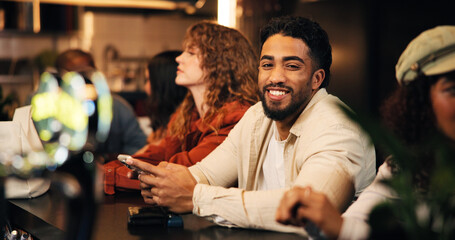 Happy man, waiting and bartender with phone for drink or hospitality service in local pub. Male person, group or customer with smile or mobile smartphone for night out, review or late evening in cafe