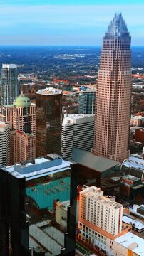Densely built architecture in the city downtown. Top view of Charlotte, North Carolina, USA at daytime. Vertical video