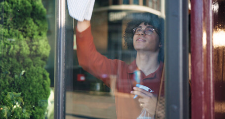 Window, cleaning and spray with man in cafe for small business owner, hygiene and entrance shine....