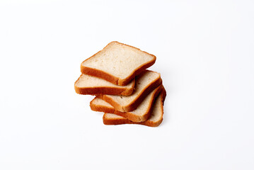A stack of four slices of bread on a white background. The bread is toasted and looks fresh