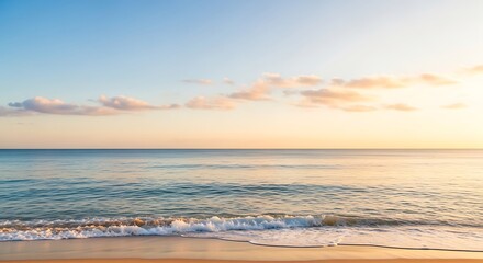 Fototapeta premium Serene Ocean Waves Gently Washing Ashore on a Golden Sandy Beach at Sunrise with a Beautiful Cloudy Sky Above