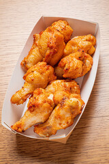 Succulent and crispy chicken wings arranged in a tray, ready to be enjoyed at a casual eatery