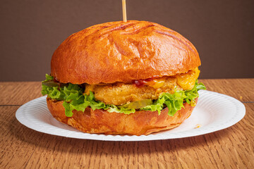 Crispy chicken burger with fresh lettuce and melted cheddar, ideal for lunch!