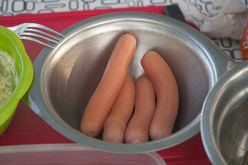 Sausages for cooking in an iron plate