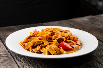 Tofu noodles on dark background. Soy cheese. Vegan food.