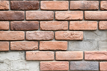 repairing old brick wall with some pieces missing, damaged red brick wall