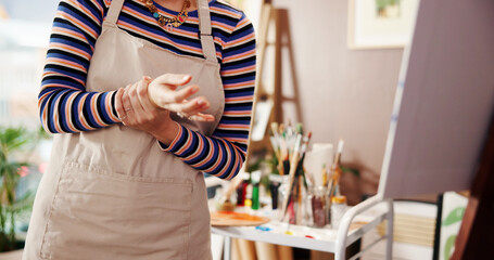 Hands, wrist pain and woman in studio, painter and carpal tunnel with muscle ache. Inflammation,...