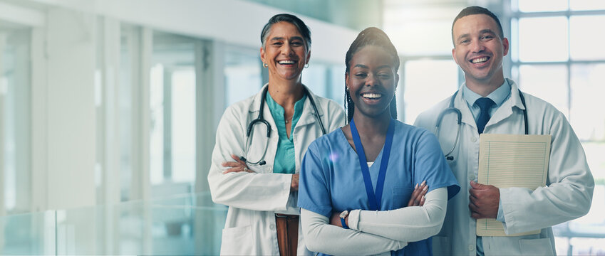 Doctors, team and arms crossed in portrait, smile and pride for medical career in hospital corridor. Healthcare professional, women and man with solidarity, happy and services at wellness clinic