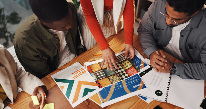 Hands, graphic designer and documents with team at office with review, above or project management. Person, group and problem solving for marketing proposal, meeting or inspiration at creative agency - Powered by Adobe