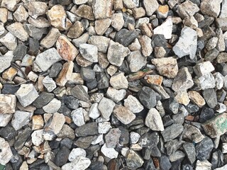 A close-up view of a pile of crushed gravel stones in various shades of gray and brown. Perfect for...