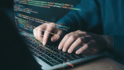 Hands typing code on a laptop screen with glowing digital data