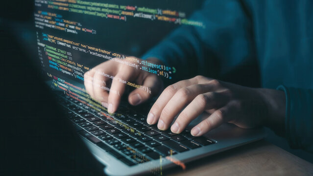 Hands typing code on a laptop screen with glowing digital data - Powered by Adobe