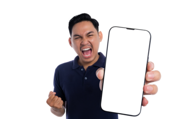 Angry young man shouting while showing blank screen smartphone in frustration wearing navy blue polo shirt isolated on transparent background