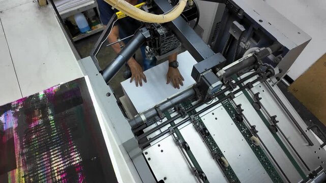 Top-down view of an offset printing machine in operation