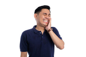 Asian man suffering from toothache with painful facial expression and hand on cheek isolated on...