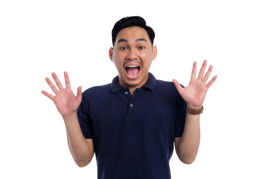 Surprised Asian man raising hands with wide eyes and open mouth expressing shock isolated on transparent background