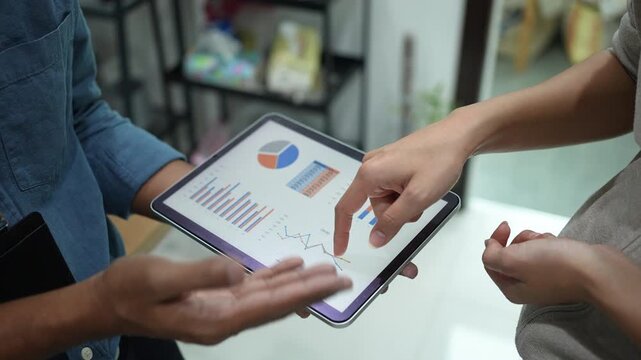 slow motion scene team of marketing hand try to explaining about company's graph profit with employee  to help and advice about marketing strategy concept