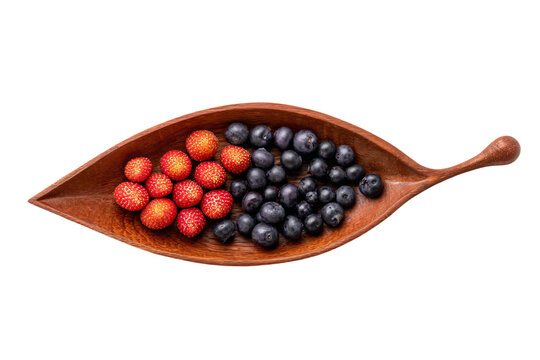 a wooden spoon filled with blueberries and strawberries - Powered by Adobe