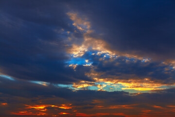 Dramatic sunset cloudscape with colorful clouds. Clouds illuminated by the setting sun, creating a captivating panorama. Beautiful twilight with the clouds catching the last rays of light