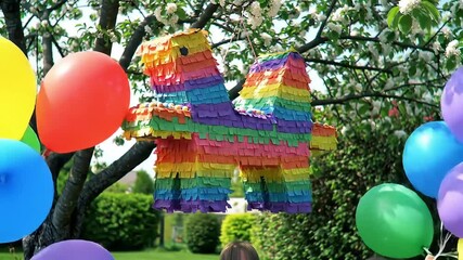 Festive Pinata Hanging from a Tree Party Fun & Celebrations - Powered by Adobe