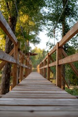 Wooden suspension bridge leading through lush forest canopy