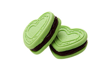 two green cookies with chocolate filling in the shape of hearts