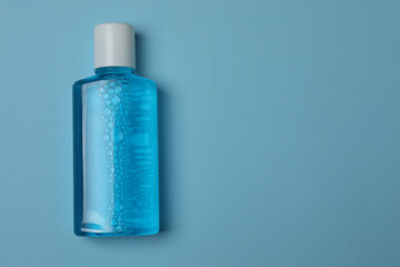 toothbrush, toothpaste, dental floss, tooth rinse on a blue background