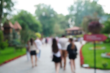 Blurred background. A beautiful park with people. The background image.